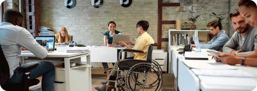 person with disability comfortably using macbook