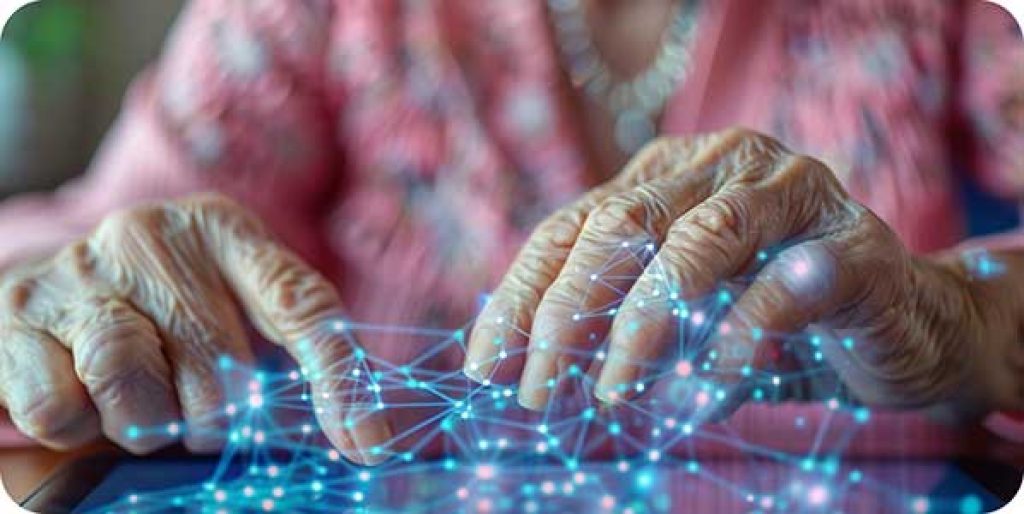 A close-up of an older adult’s hands using a touchscreen device with communication symbols.