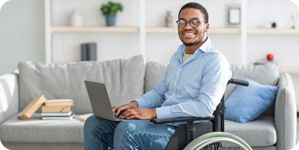 A person with a disability on a computer checking off and validating accessibility issues. 